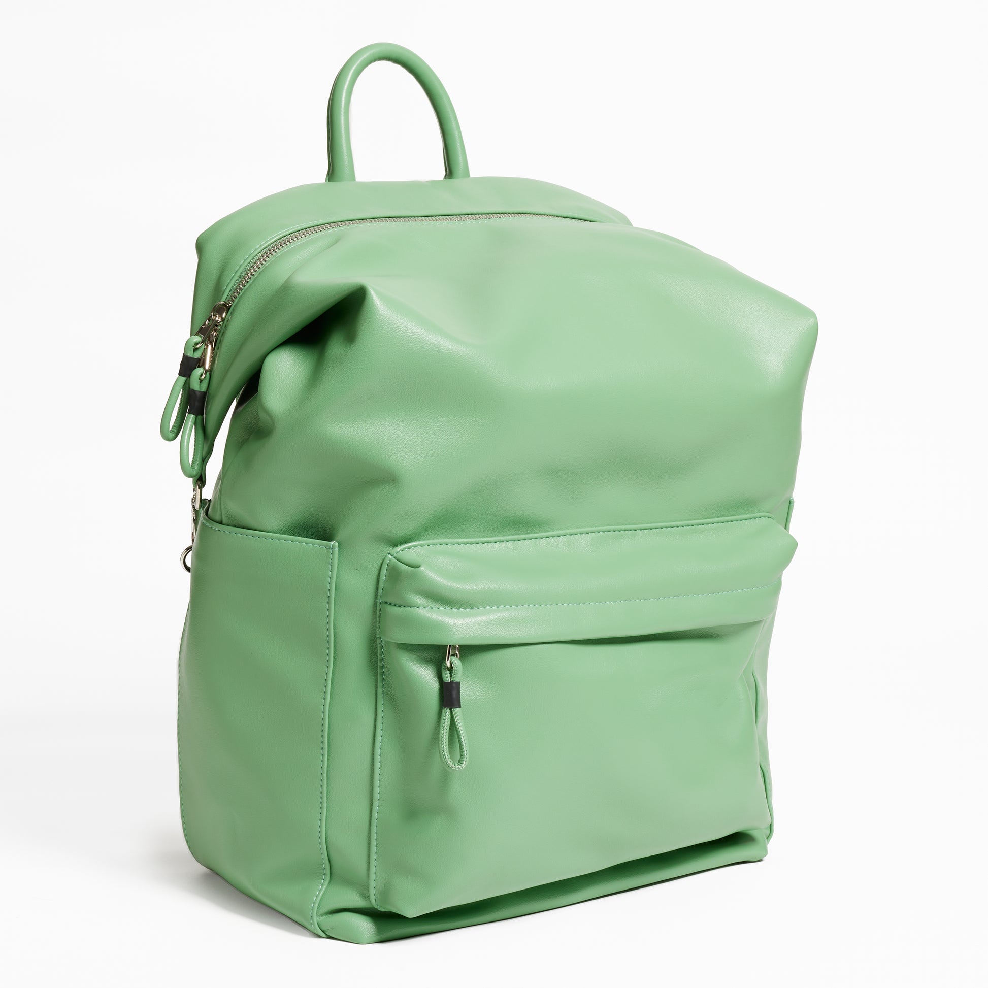 Angled Front Facing view of the Karma Backpack in Aloe Green colored Vegan Leather. Backpack has a top handle and a convertible strap to carry your backpack as a tote for easy grab and go!